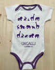 Organic baby onesie in white with purple accents and animal design