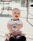 Organic baby onesie in white with grey "Born in Tbay" logo on front