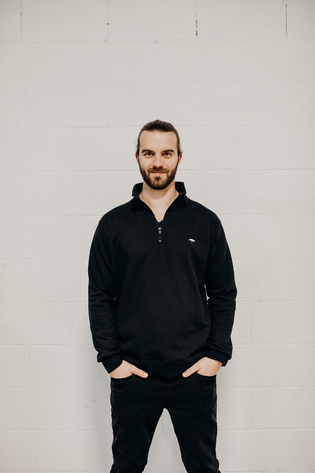 Unisex ethically made black 1/4 zip sweater with small white Ungalli tree on front
