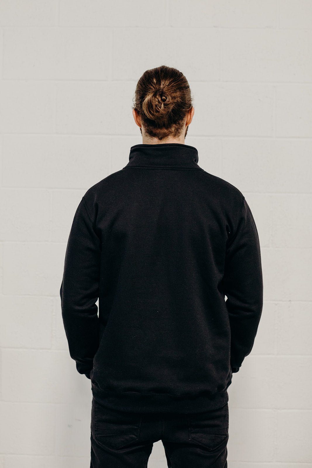 Unisex ethically made black 1/4 zip sweater with small white Ungalli tree on front
