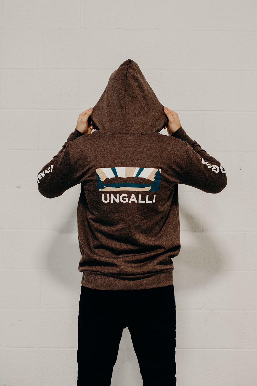 Brown organic unisex zip up hoodie with multi coloured  'Nanabijou' design and white text