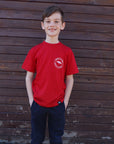 Children's recycled red t-shirt with small white "Born in Tbay" logo on front