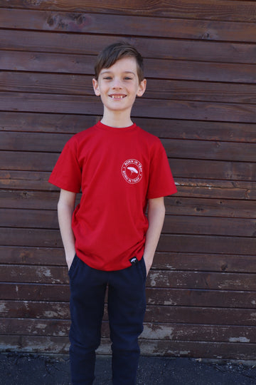 Children's recycled red t-shirt with small white "Born in Tbay" logo on front