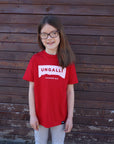 Children's recycled red t-shirt with white accents and sleeping giant outline across front
