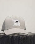 Unisex recycled snap back hat in grey or black with white Ungalli logo on front