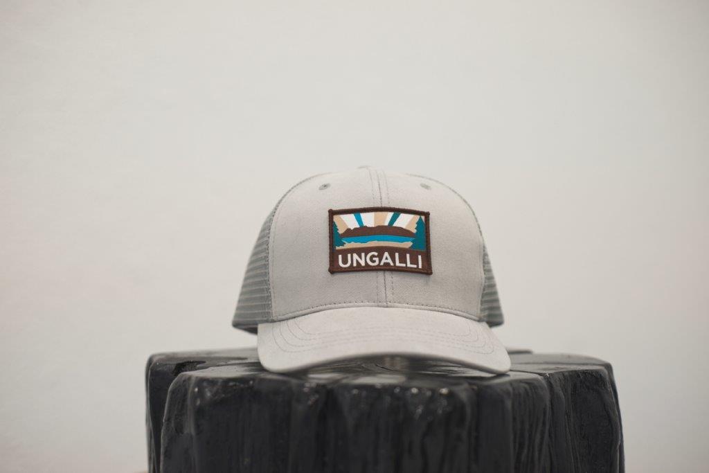 Unisex organic snap back hat in grey or black with multicoloured Ungalli/sleeping giant design on front
