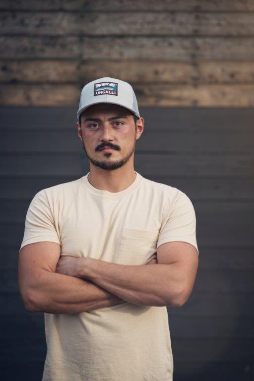 Unisex organic snap back hat in grey or black with multicoloured Ungalli/sleeping giant design on front