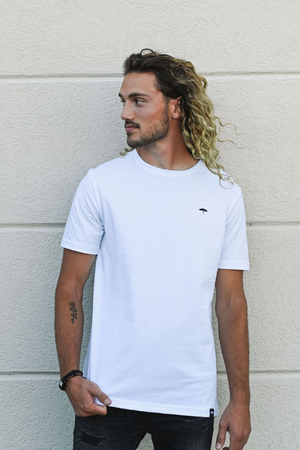 White unisex organically made t-shirt with black text on back