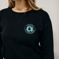 Women's sustainably made black cropped hoodie with brand logo