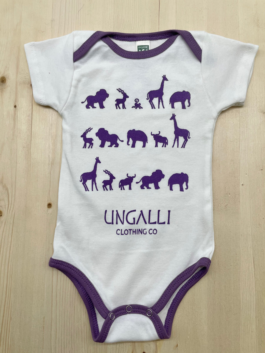 Organic baby onesie in white with purple accents and animal design