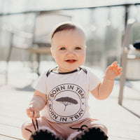 Organic baby onesie in white with grey "Born in Tbay" logo on front