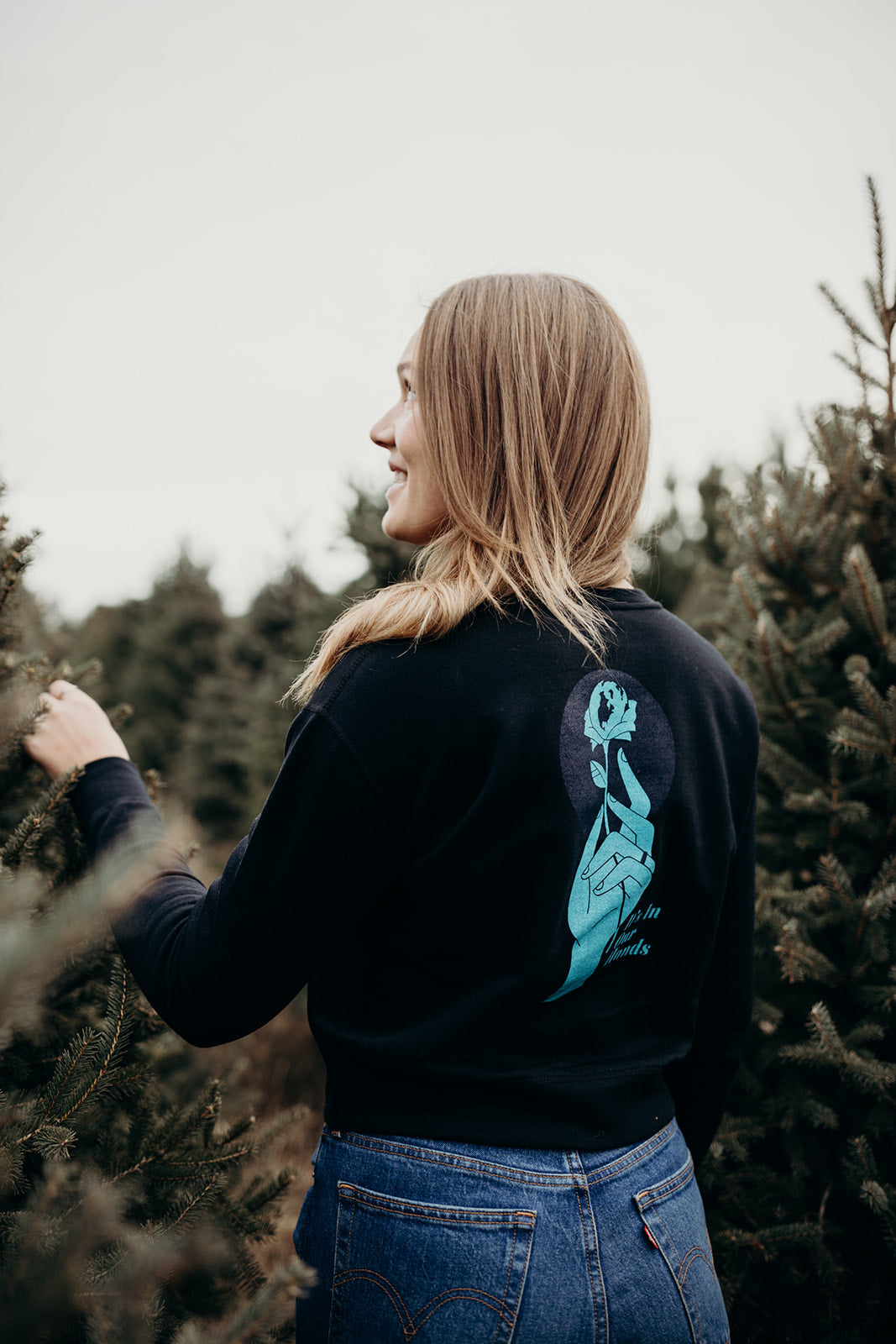 Women's sustainably made black cropped hoodie with brand logo