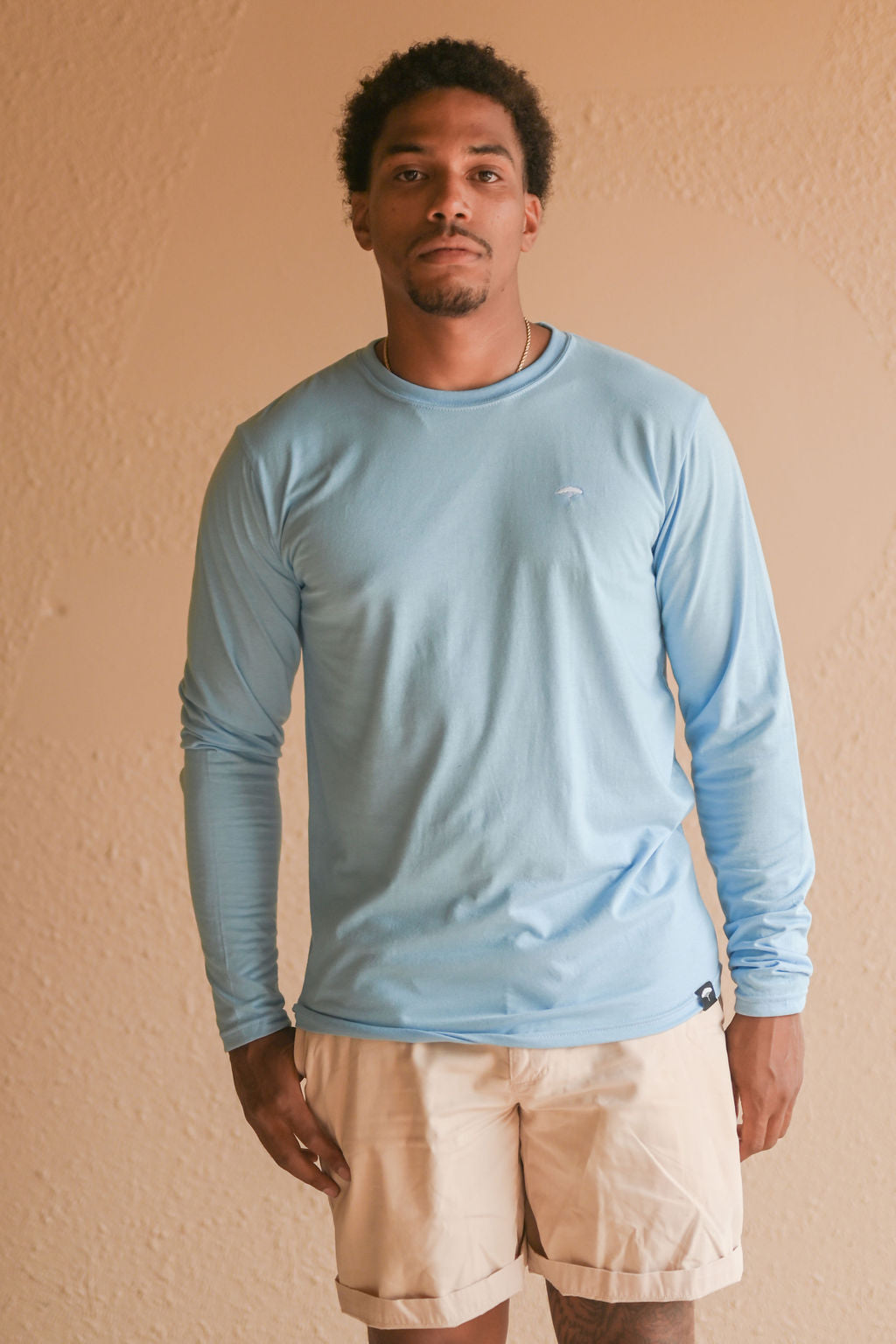 Light blue recycled unisex long sleeve shirt with small white Ungalli tree on front