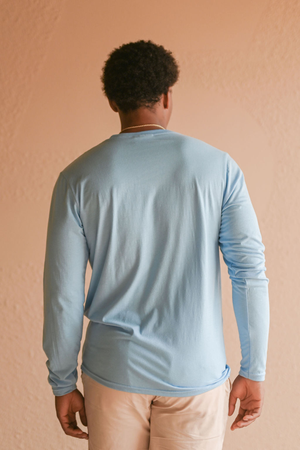 Light blue recycled unisex long sleeve shirt with small white Ungalli tree on front