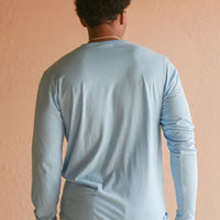 Light blue recycled unisex long sleeve shirt with small white Ungalli tree on front