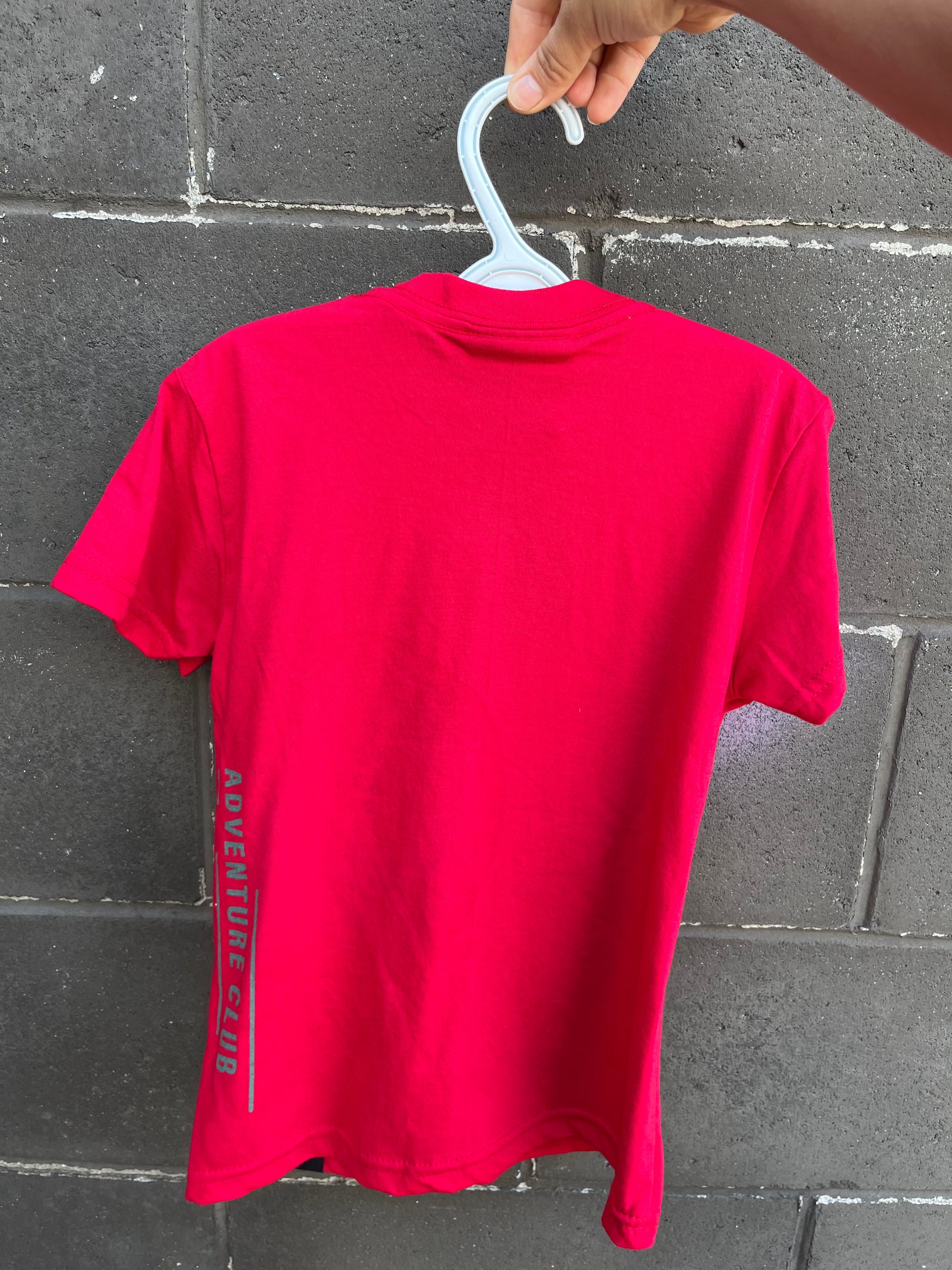 Kids red organic t-shirt with multi coloured 'adventure club' logo