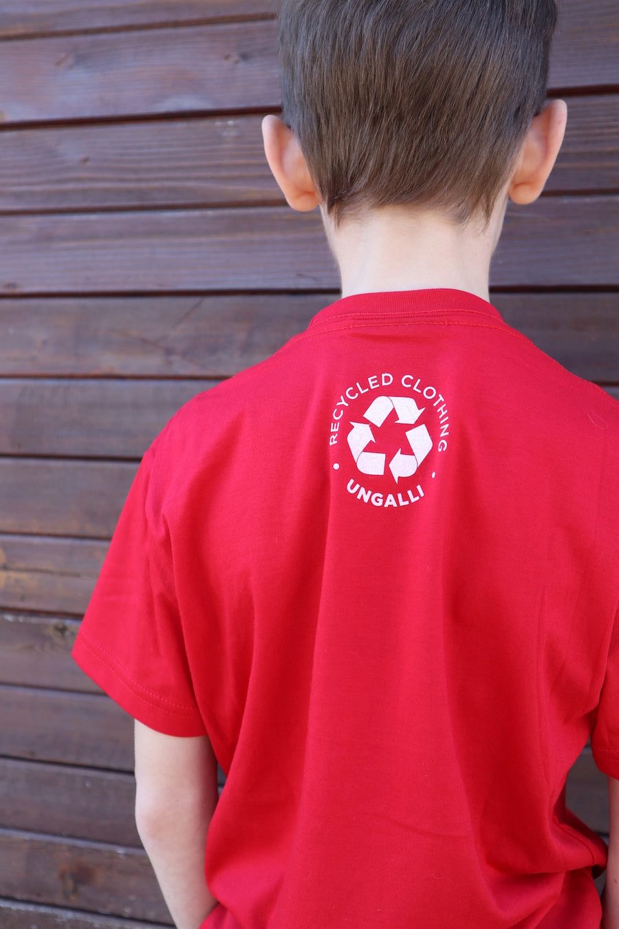 Children's recycled red t-shirt with small white "Born in Tbay" logo on front