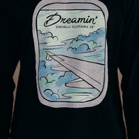 Unisex recycled long sleeve black shirt with Dreamin' airplane design on front and text on back