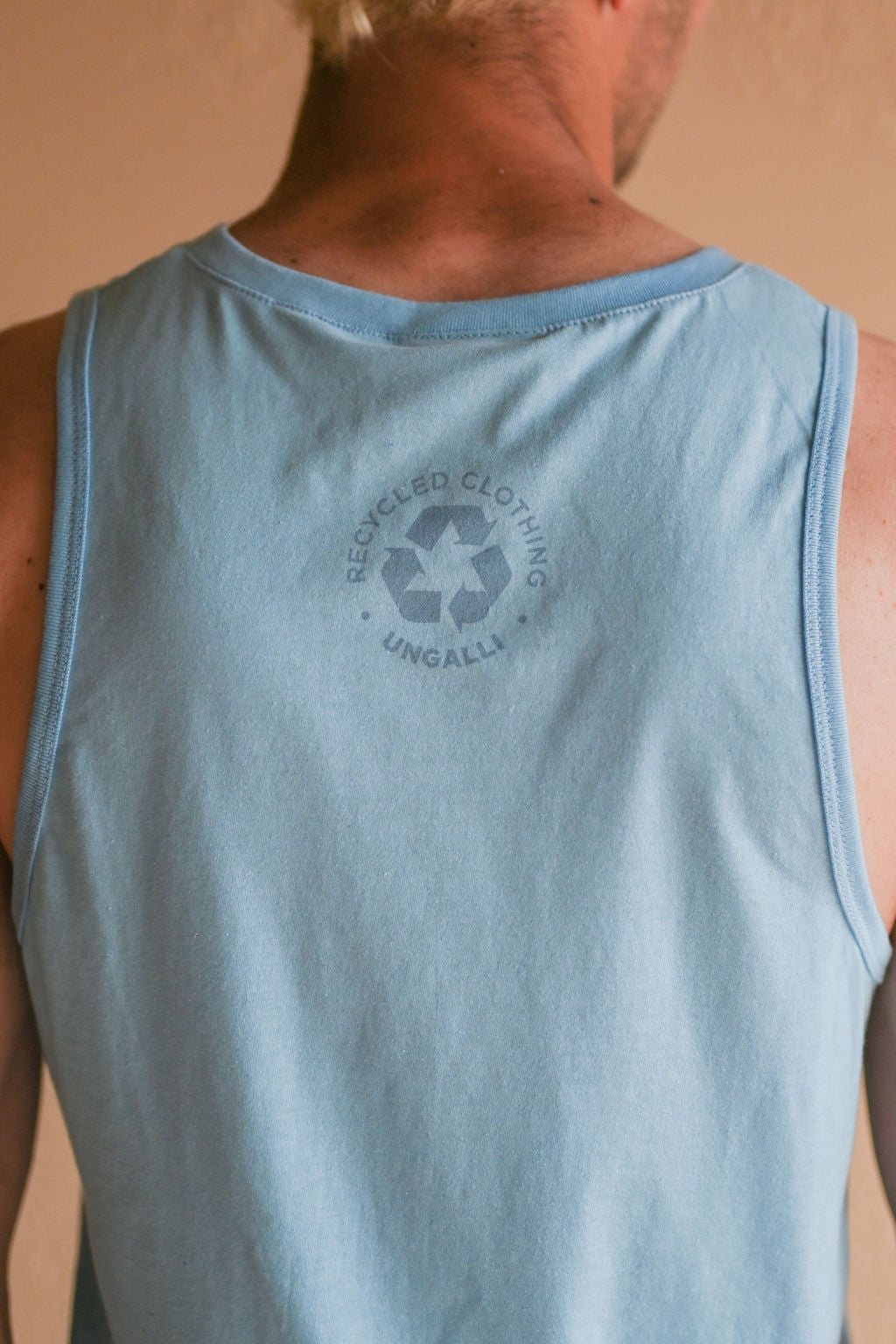 Light blue men's tank top with but Ungalli logo across front