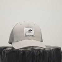 Unisex recycled snap back hat in grey or black with white Ungalli logo on front