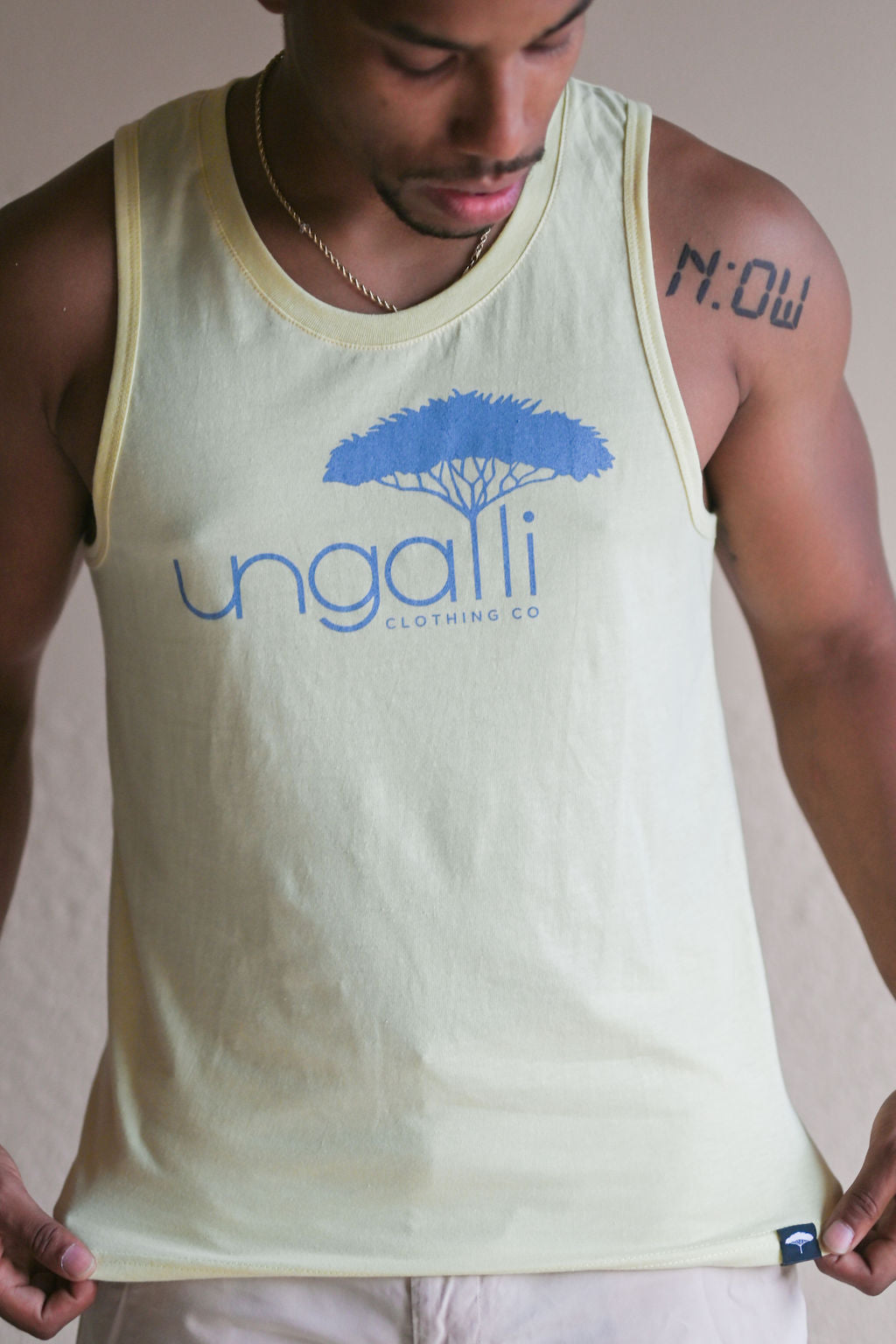 Men's recycled yellow tank top with light blue Ungalli logo across front