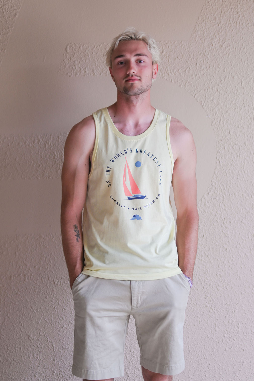 Men's yellow ethically made tank top with sail boat 'greatest lake' design on front