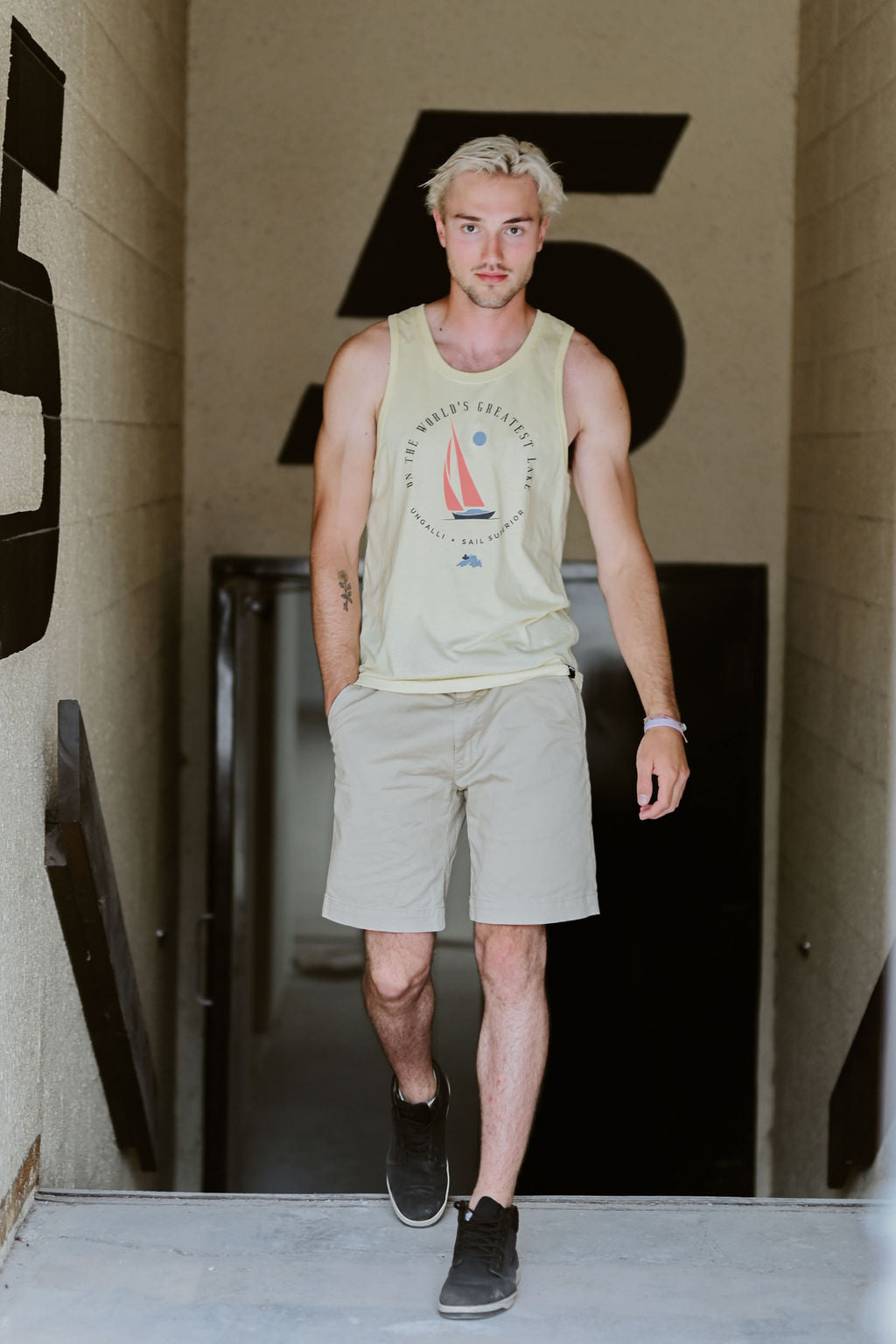 Men's yellow ethically made tank top with sail boat 'greatest lake' design on front