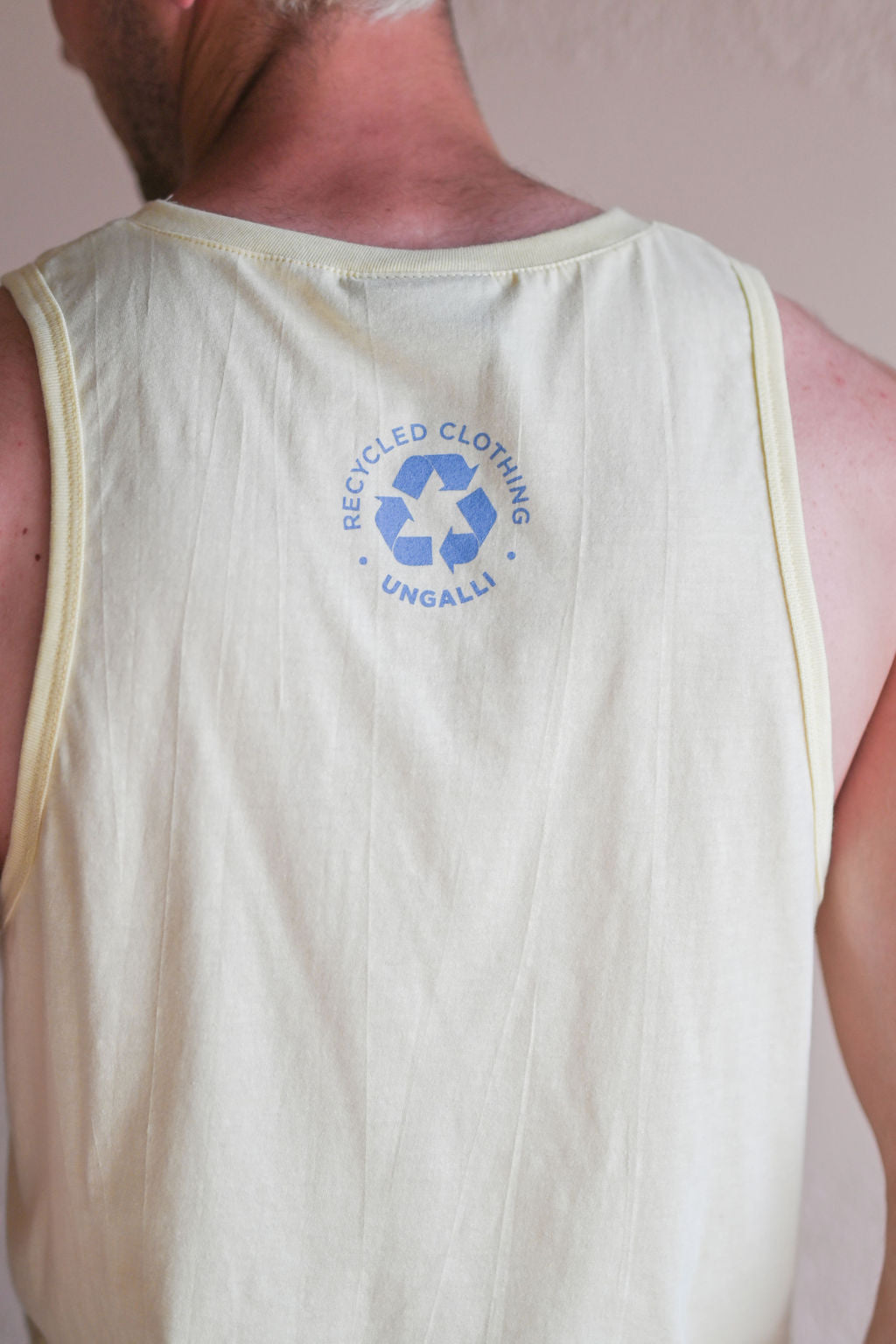 Men's yellow ethically made tank top with sail boat 'greatest lake' design on front