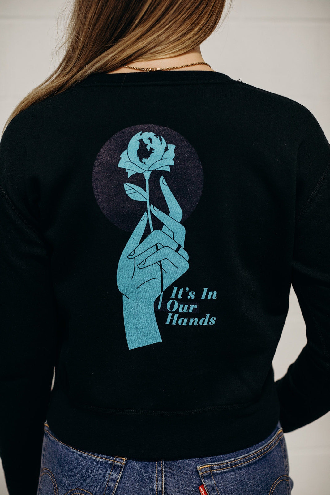 Women's sustainably made black cropped hoodie with brand logo