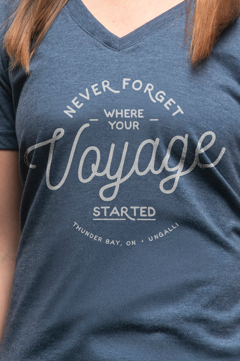 Women's short sleeve organic blue t-shirt with text reading: "Never forget where your voyage starts"