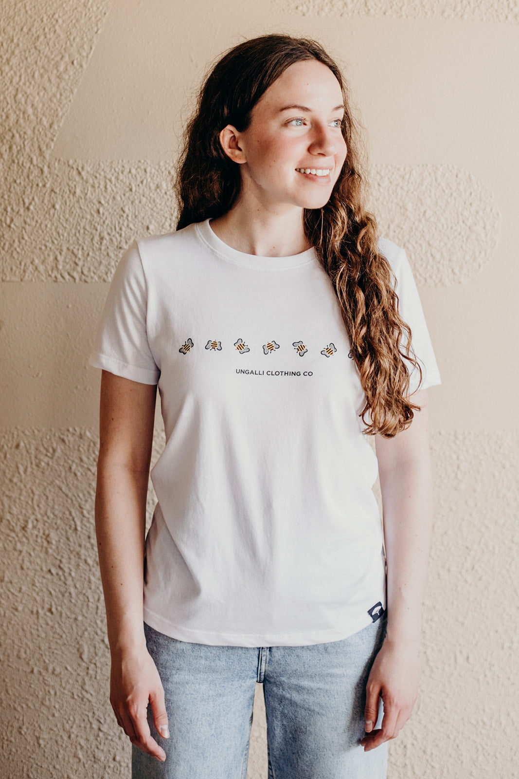 Women's white organically made t-shirt with bee design on front