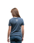 Women's short sleeve organic blue t-shirt with text reading: "Never forget where your voyage starts"