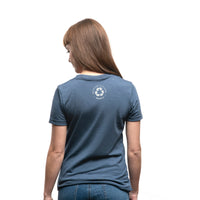 Women's short sleeve organic blue t-shirt with text reading: "Never forget where your voyage starts"