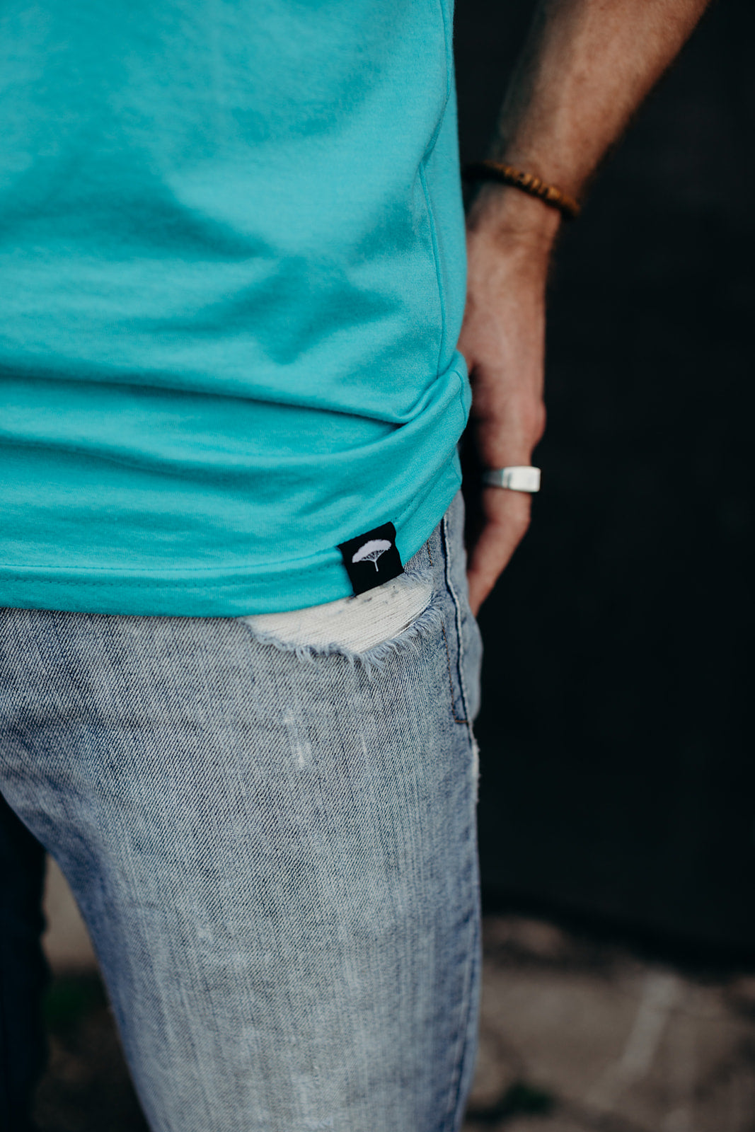 Men's organic teal tank top with white details