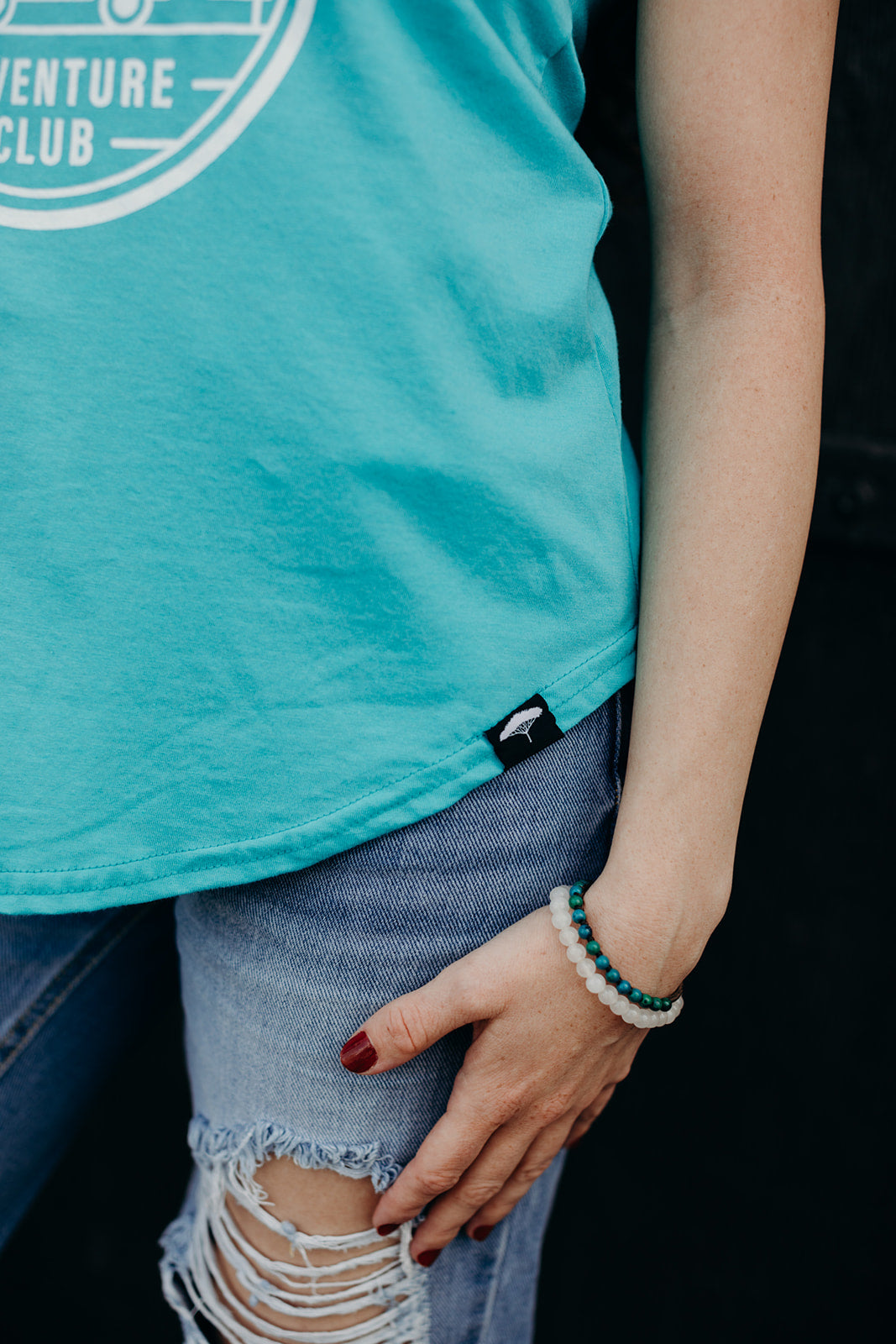 Women's organic teal tank top with white 'adventure club' logo