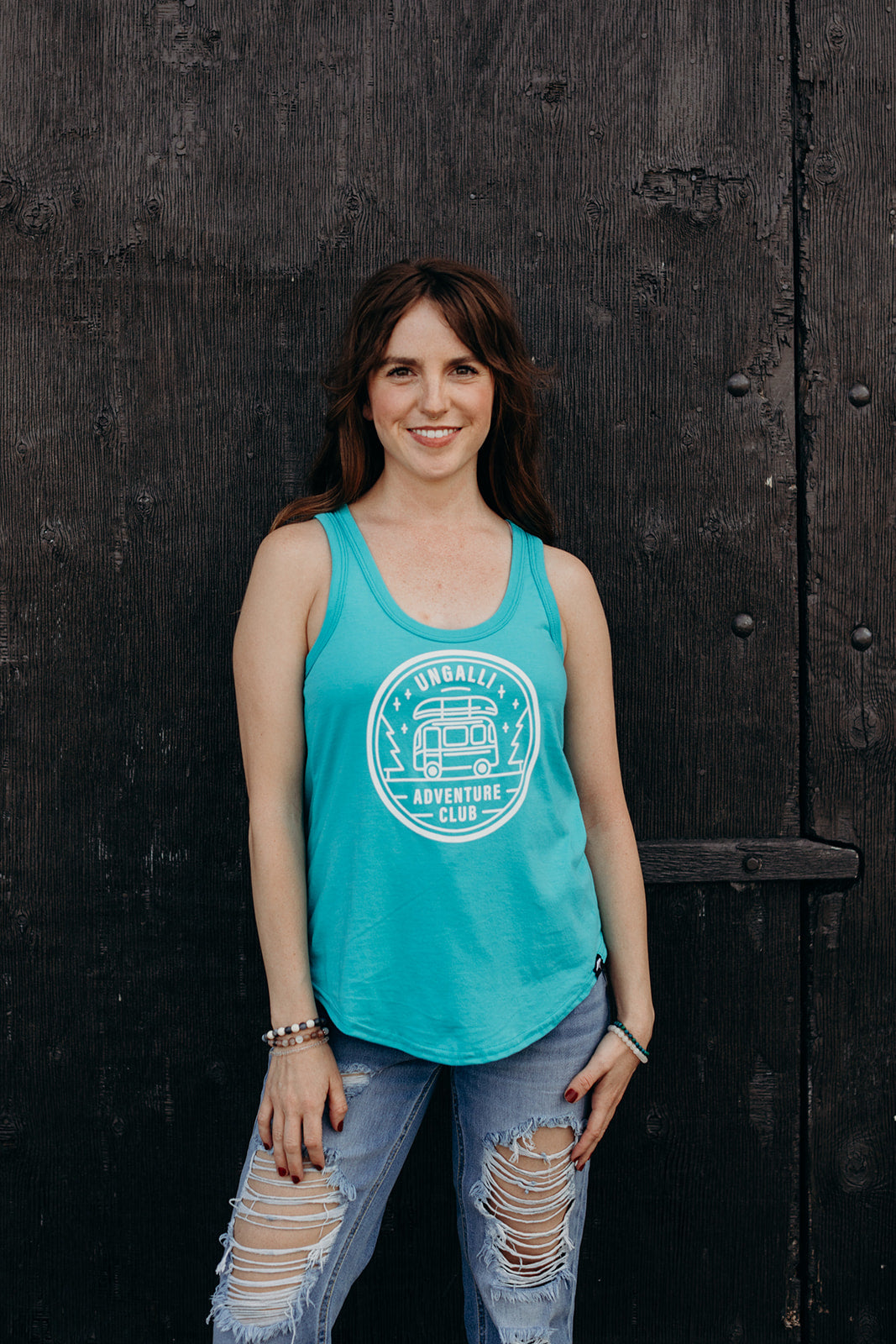 Women's organic teal tank top with white 'adventure club' logo