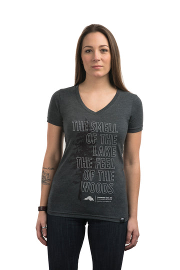 Women's short sleeve grey organic t-shirt with white text on front that reads: "The smell of lake the feel of the woods" 
