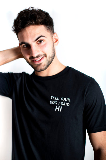 Unisex recycled t-shirt in black with "Tell your dig i said hi" in white text on front