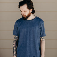 Unisex short sleeve blue ethically made t-shirt with 'still we rise' rose design