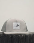 Unisex ethically made flat brim snapback hat in black or grey with white Ungalli logo on front