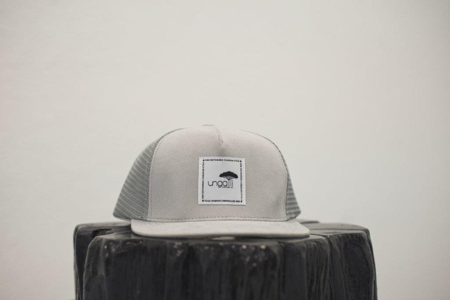 Unisex ethically made flat brim snapback hat in black or grey with white Ungalli logo on front