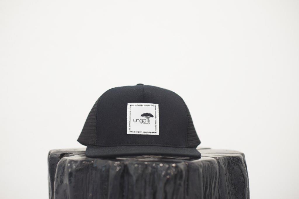 Unisex ethically made flat brim snapback hat in black or grey with white Ungalli logo on front