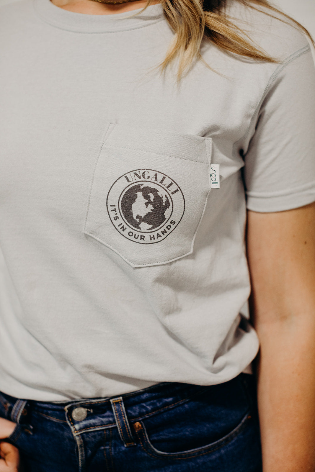 Ethically made grey short sleeved 'In Our Hands' unisex pocket t-shirt with Earth logo