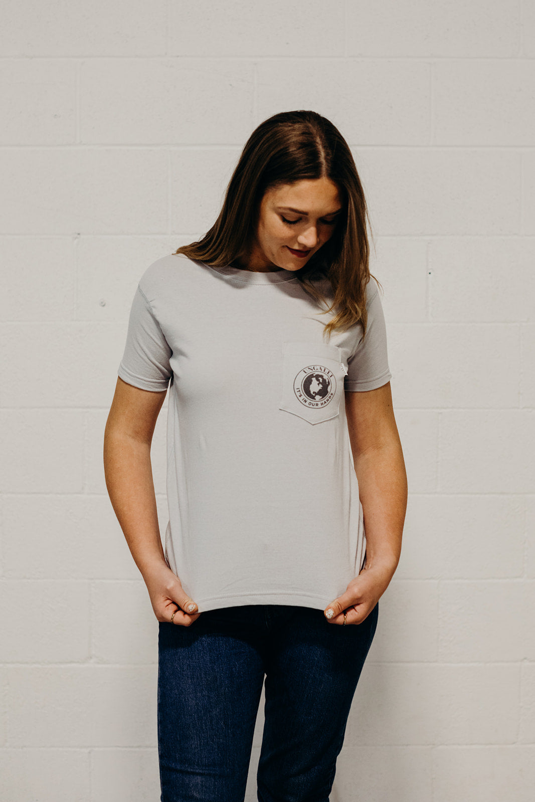 Ethically made grey short sleeved 'In Our Hands' unisex pocket t-shirt with Earth logo