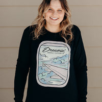 Unisex recycled long sleeve black shirt with Dreamin' airplane design on front and text on back