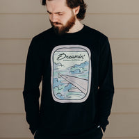 Unisex recycled long sleeve black shirt with Dreamin' airplane design on front and text on back