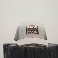 Unisex organic snap back hat in grey or black with multicoloured Ungalli/sleeping giant design on front