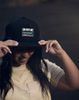 Unisex organic snap back hat in grey or black with multicoloured Ungalli/sleeping giant design on front