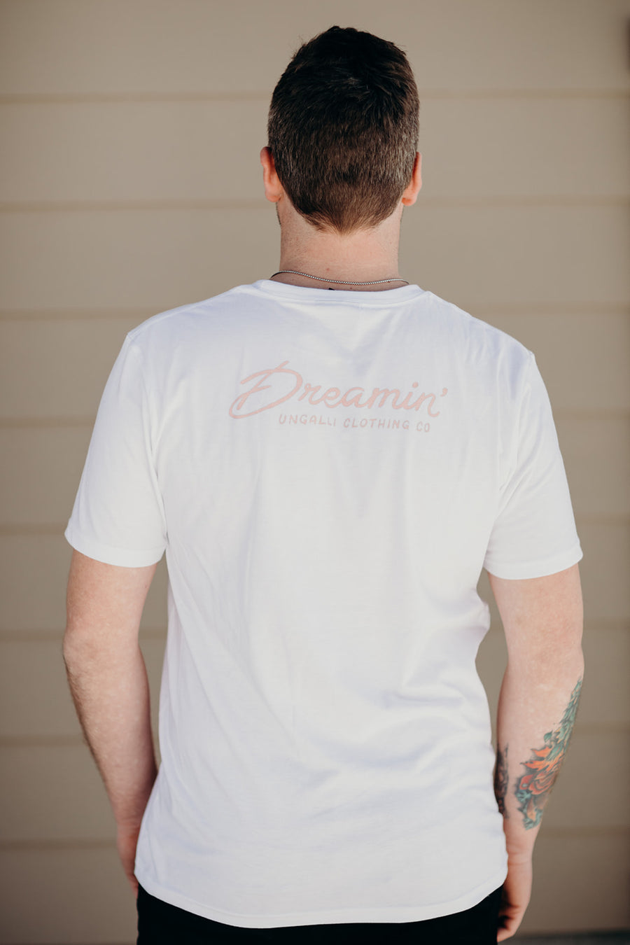 Organic white unisex t-shirt with multi-coloured dreamin' plane logo on front
