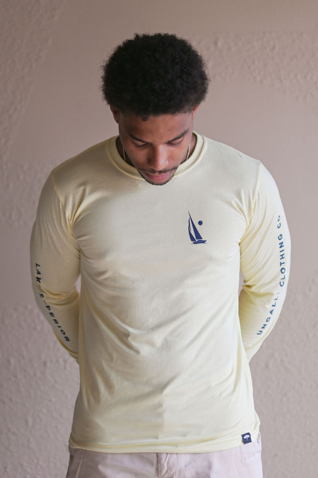 Unisex long sleeve organic shirt with blue sail boat logo and text